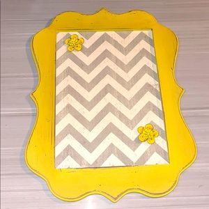 Chevron magnetic board with two flower magnets.